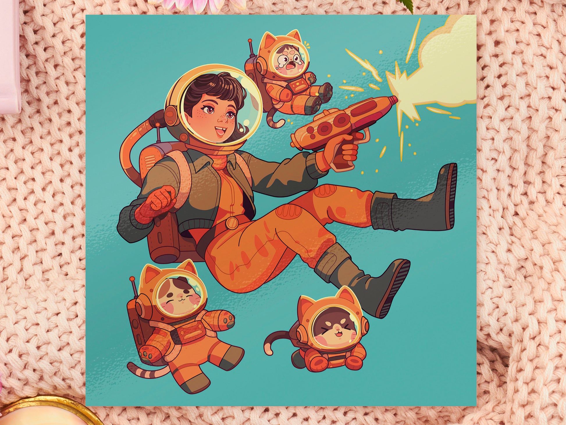 Square art print depicting a young astronaut firing a ray gun, while three adorable cats in spacesuits react.