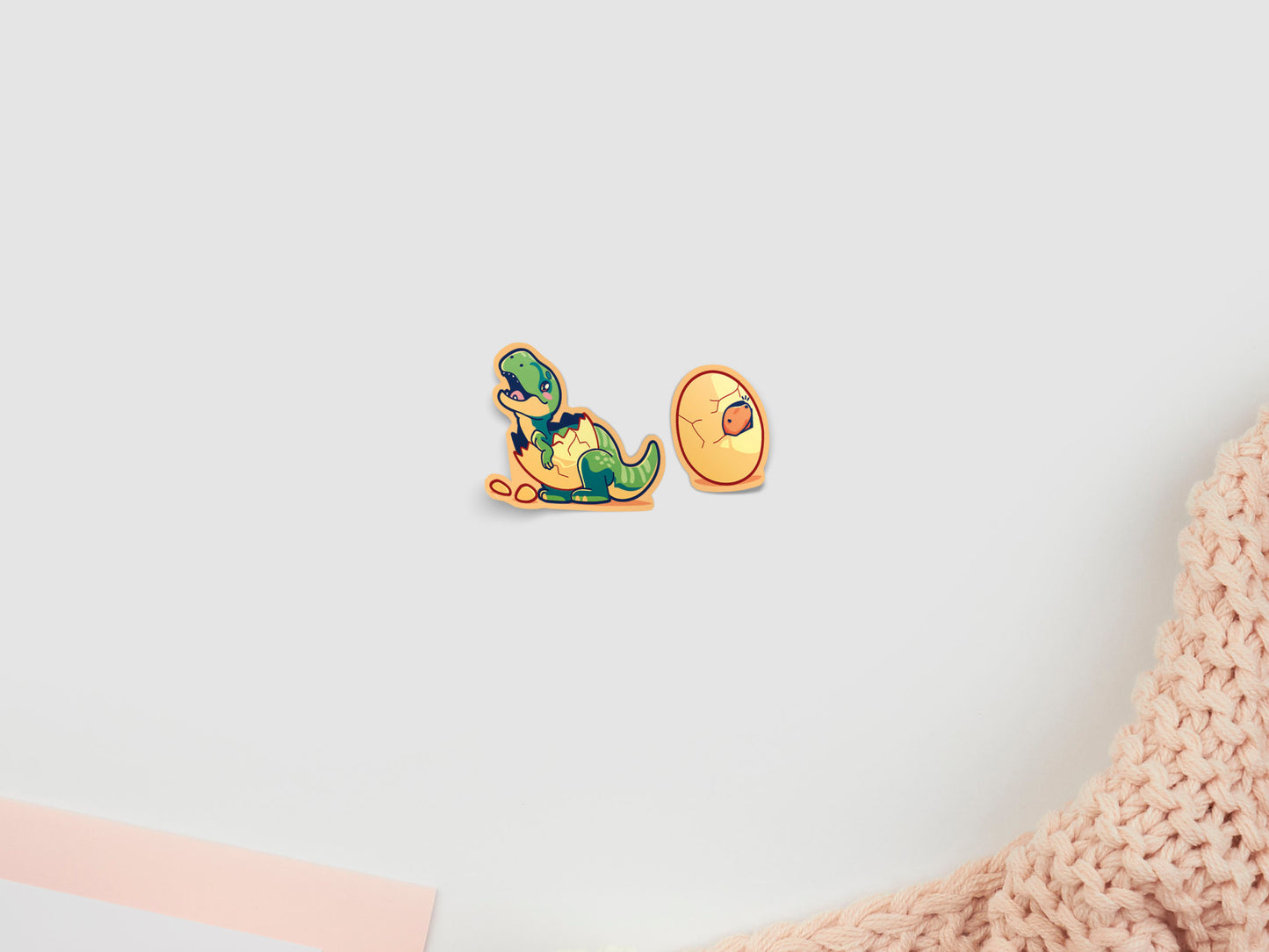 Two baby dinosaur stickers hatching from eggs