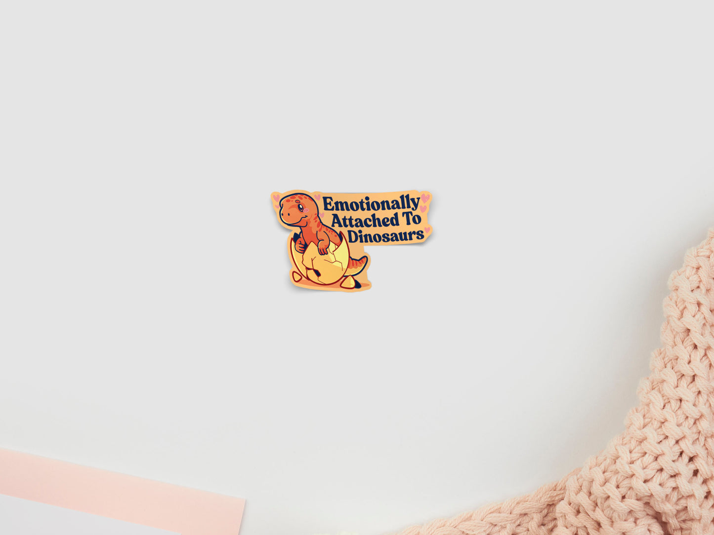 Sticker of a dinosaur with text 'Emotionally Attached To Dinosaurs' on a white background