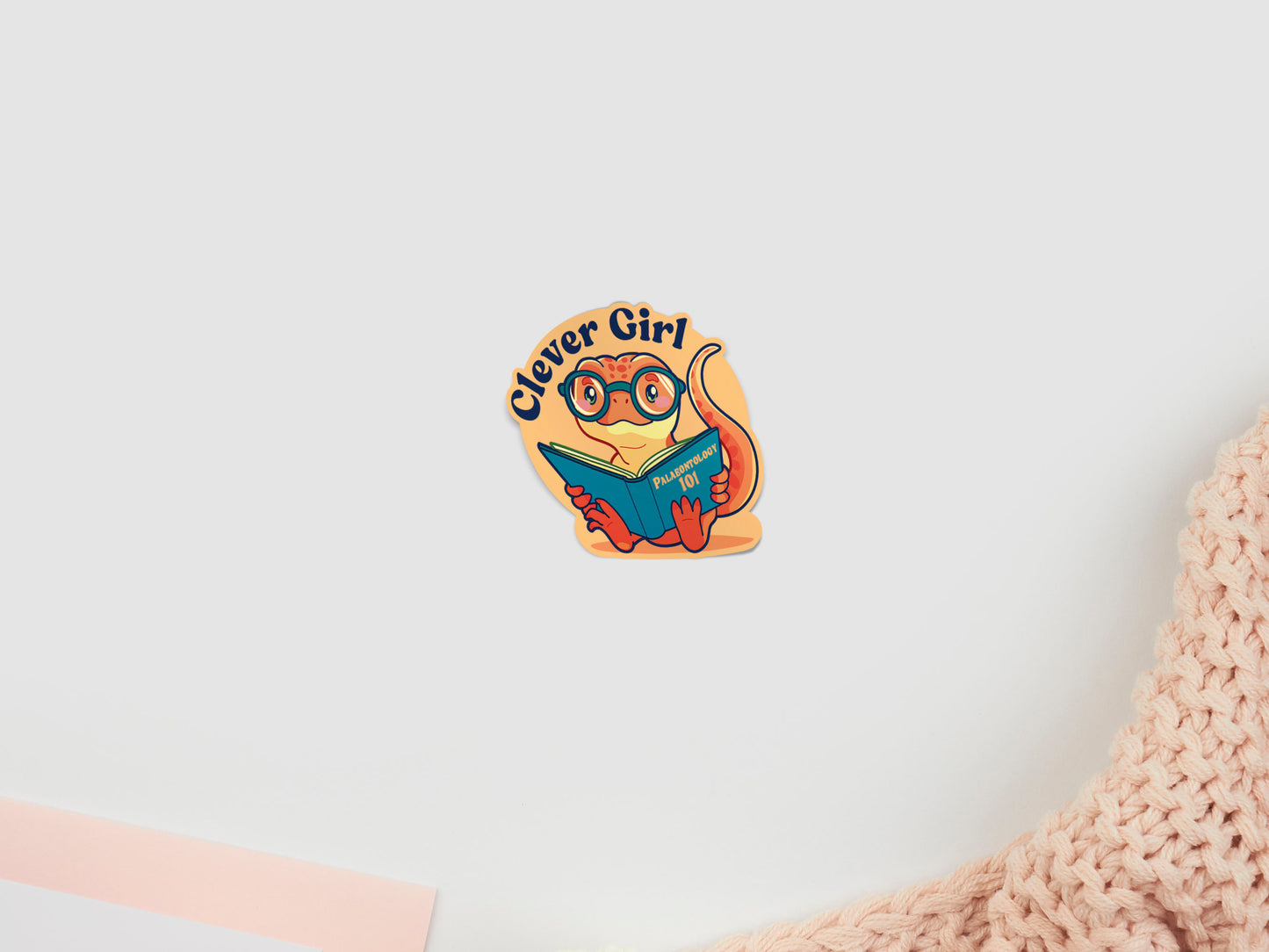 Sticker with a dinosaur design and 'Clever Girl' text on a light background