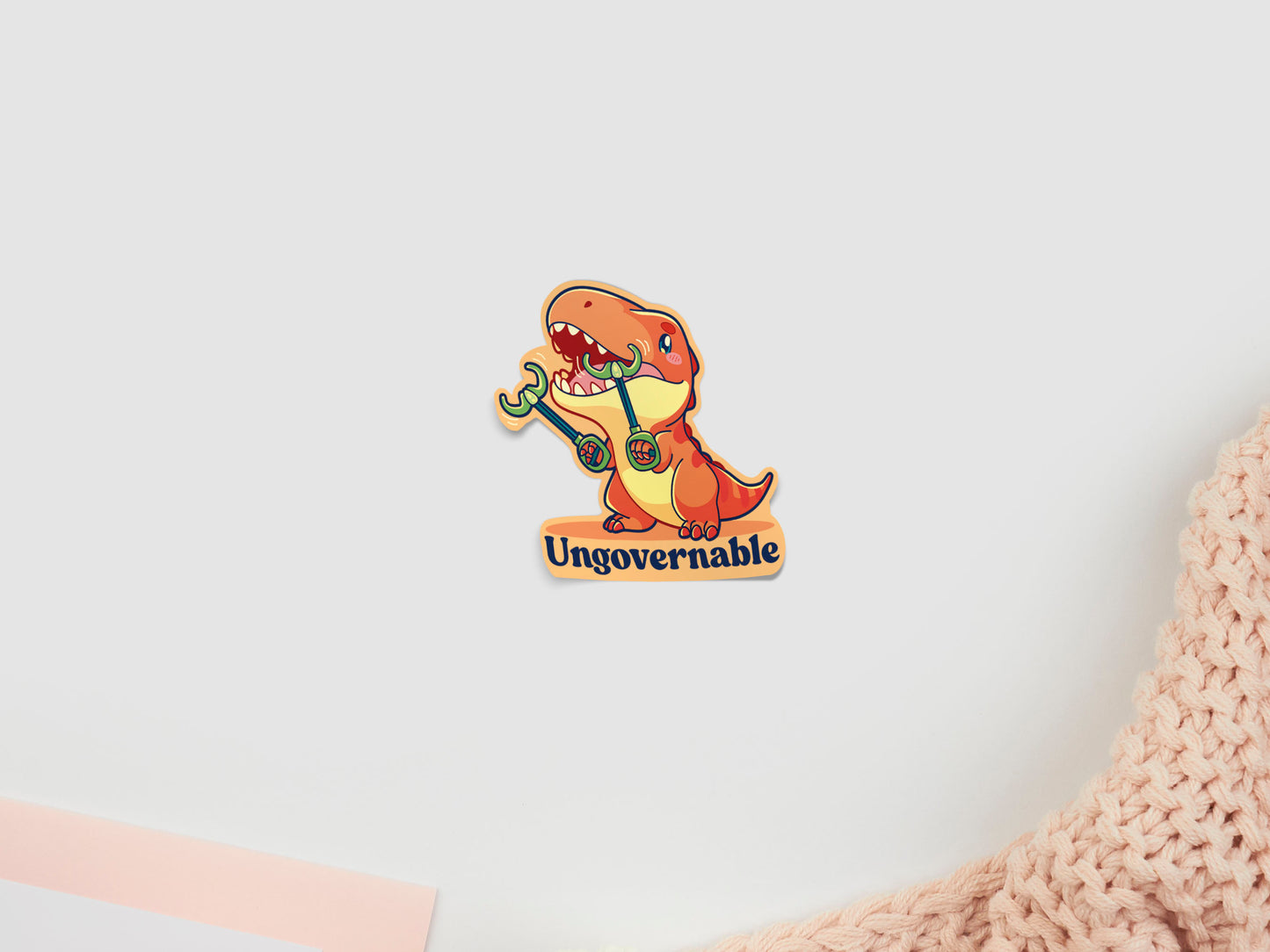 Dinosaur trex with grabby arms sticker with 'Ungovernable' text on a light background