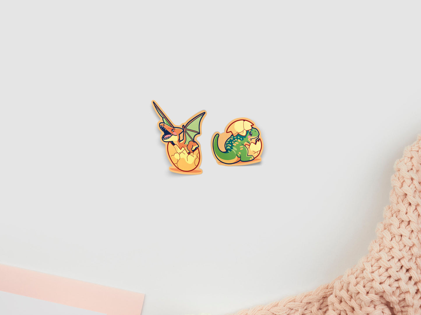 Two baby dinosaur stickers hatching from eggs