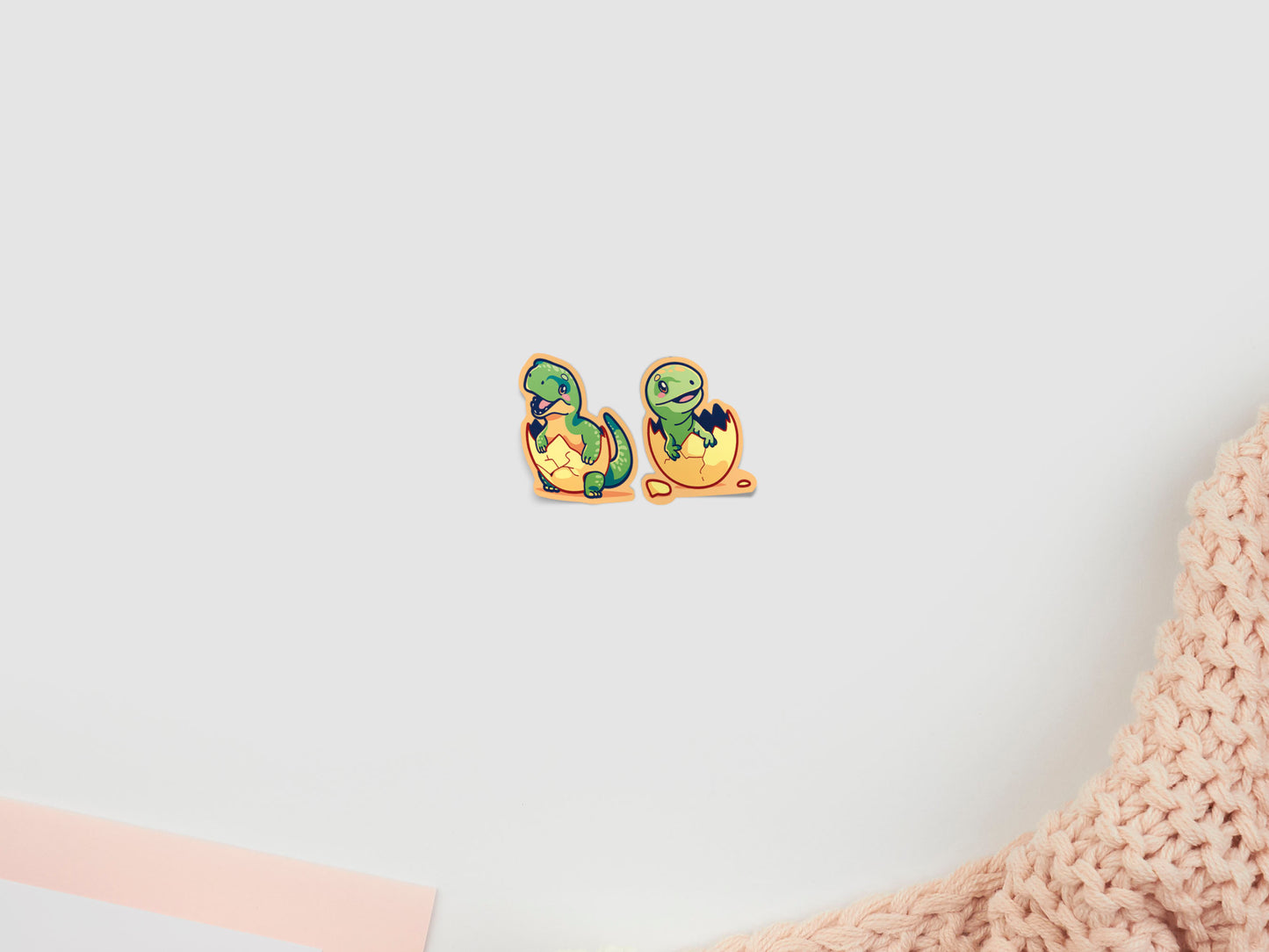 Two baby dinosaur stickers hatching from eggs