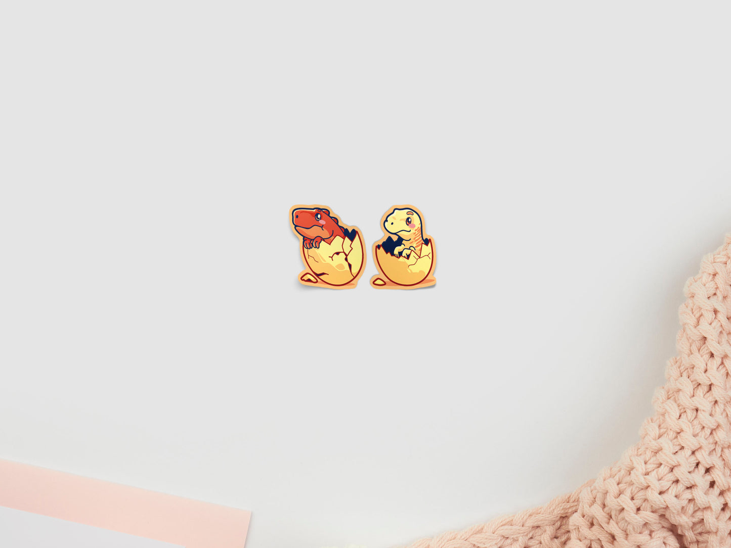 Two baby dinosaur stickers hatching from eggs