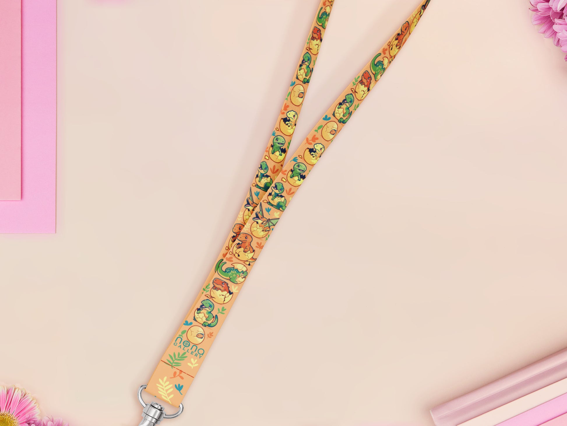 Cute full legth yellow lanyard with a double sided baby dinosuras hatcing from eggs pattern and silver swivel hook clasp.