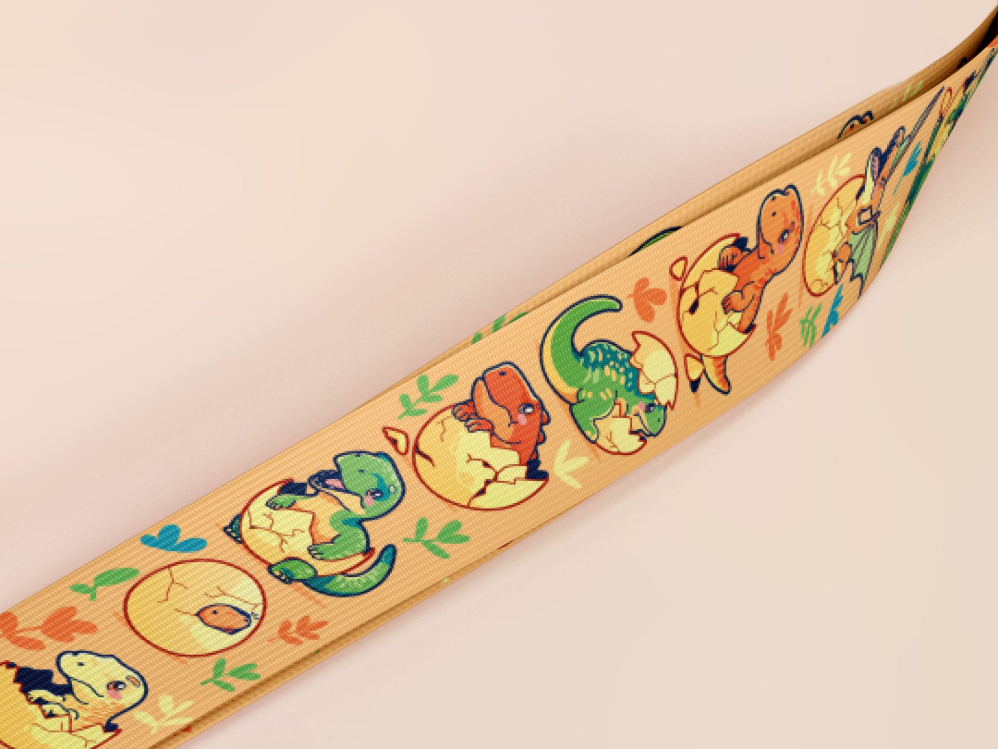 Cute full legth yellow lanyard with a double sided baby dinosuras hatcing from eggs pattern and silver swivel hook clasp.