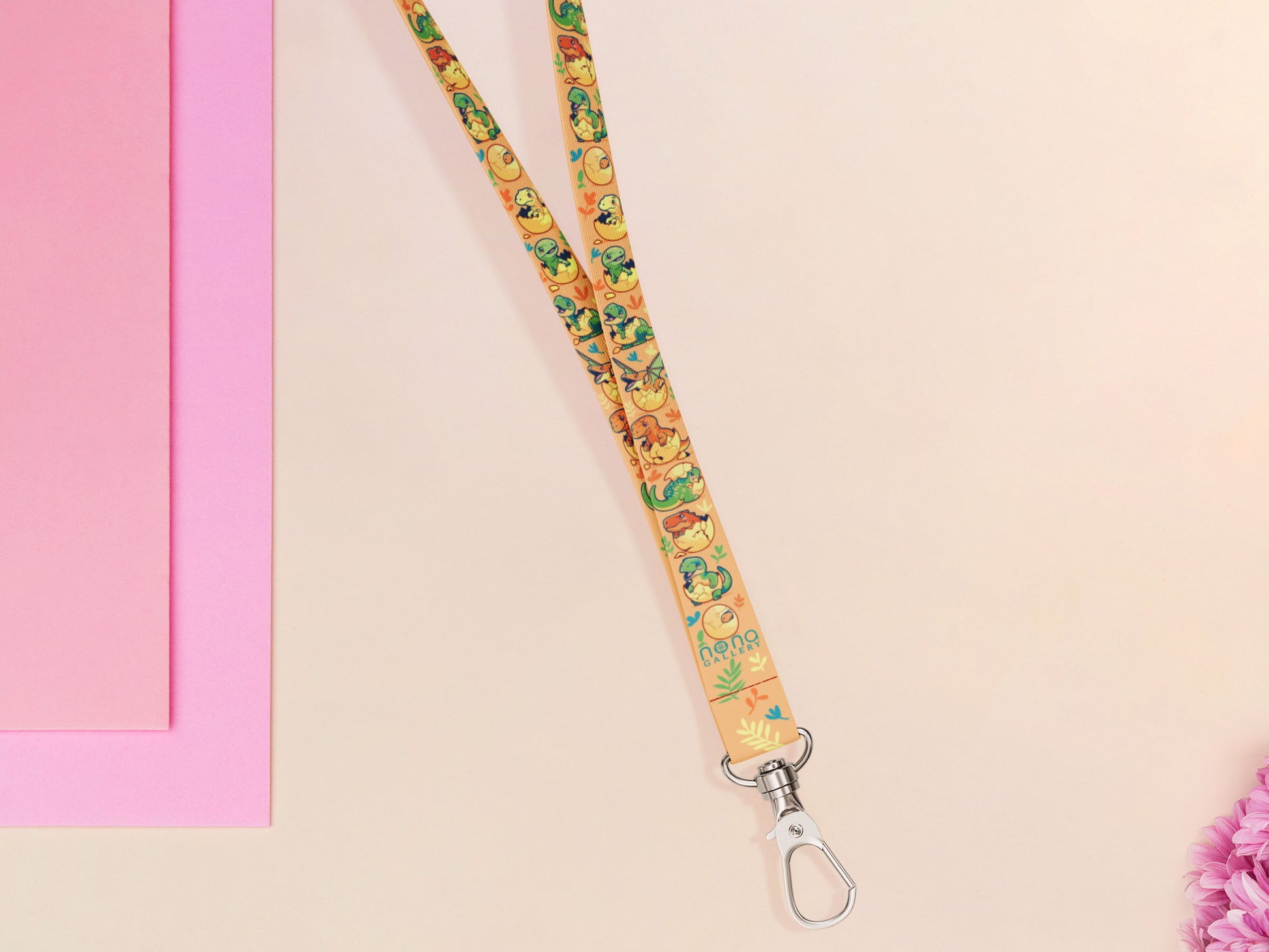 Cute full legth yellow lanyard with a double sided baby dinosuras hatcing from eggs pattern and silver swivel hook clasp.