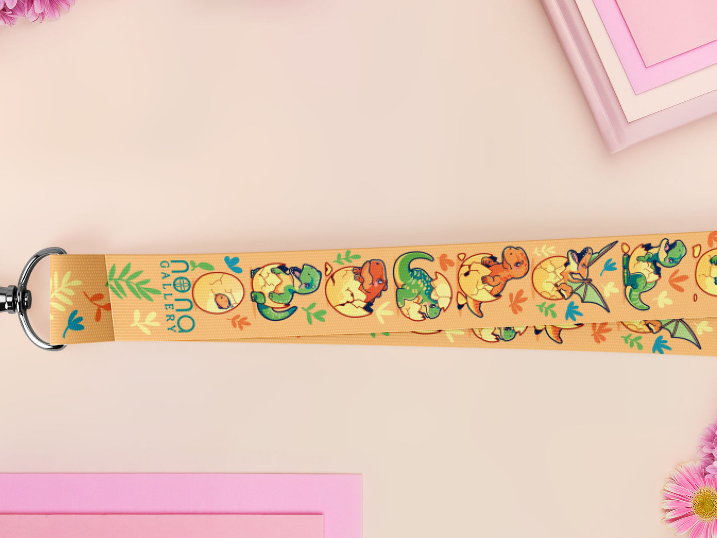 Cute full legth yellow lanyard with a double sided baby dinosuras hatcing from eggs pattern and silver swivel hook clasp.