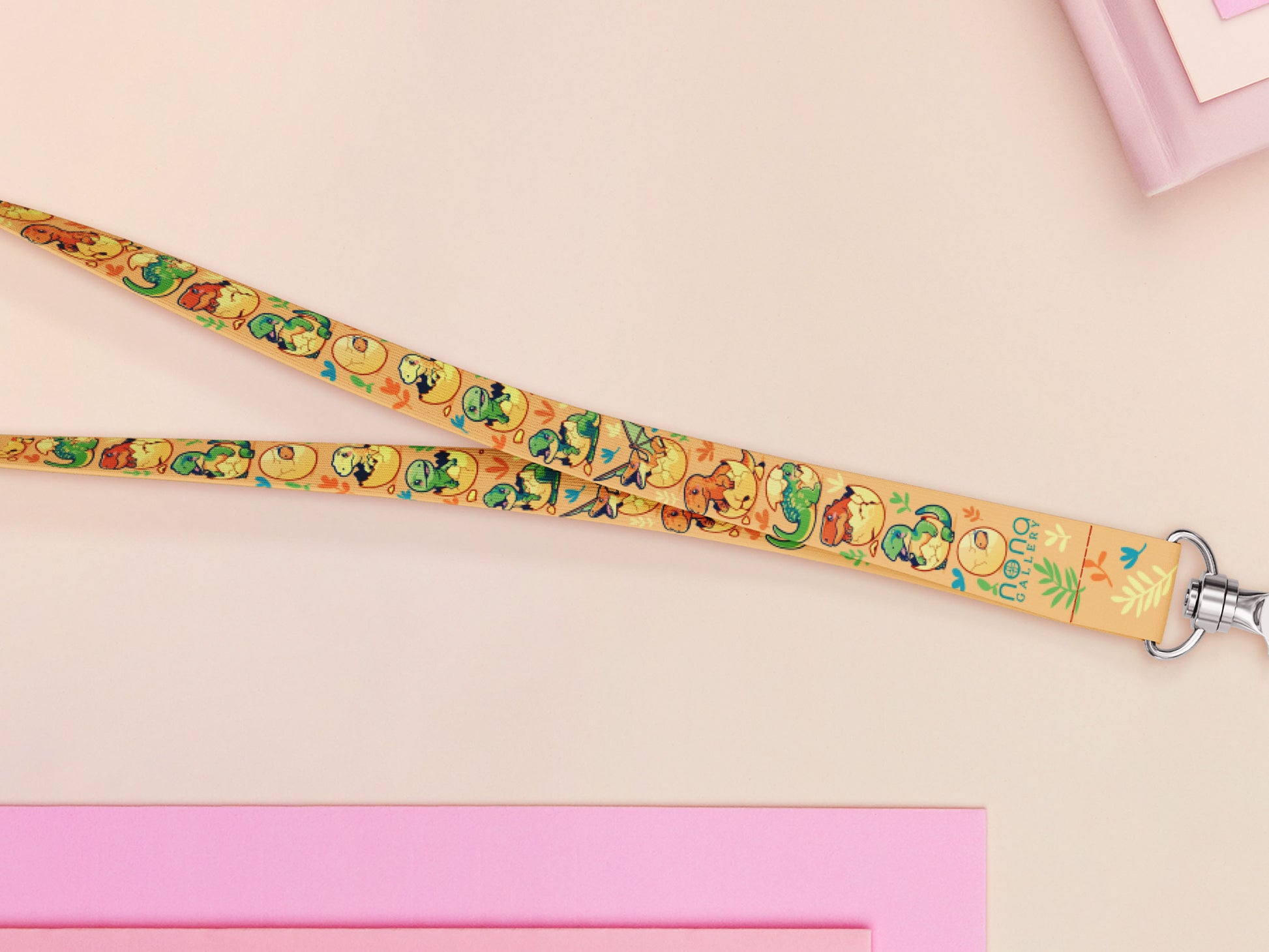 Cute full legth yellow lanyard with a double sided baby dinosuras hatcing from eggs pattern and silver swivel hook clasp.