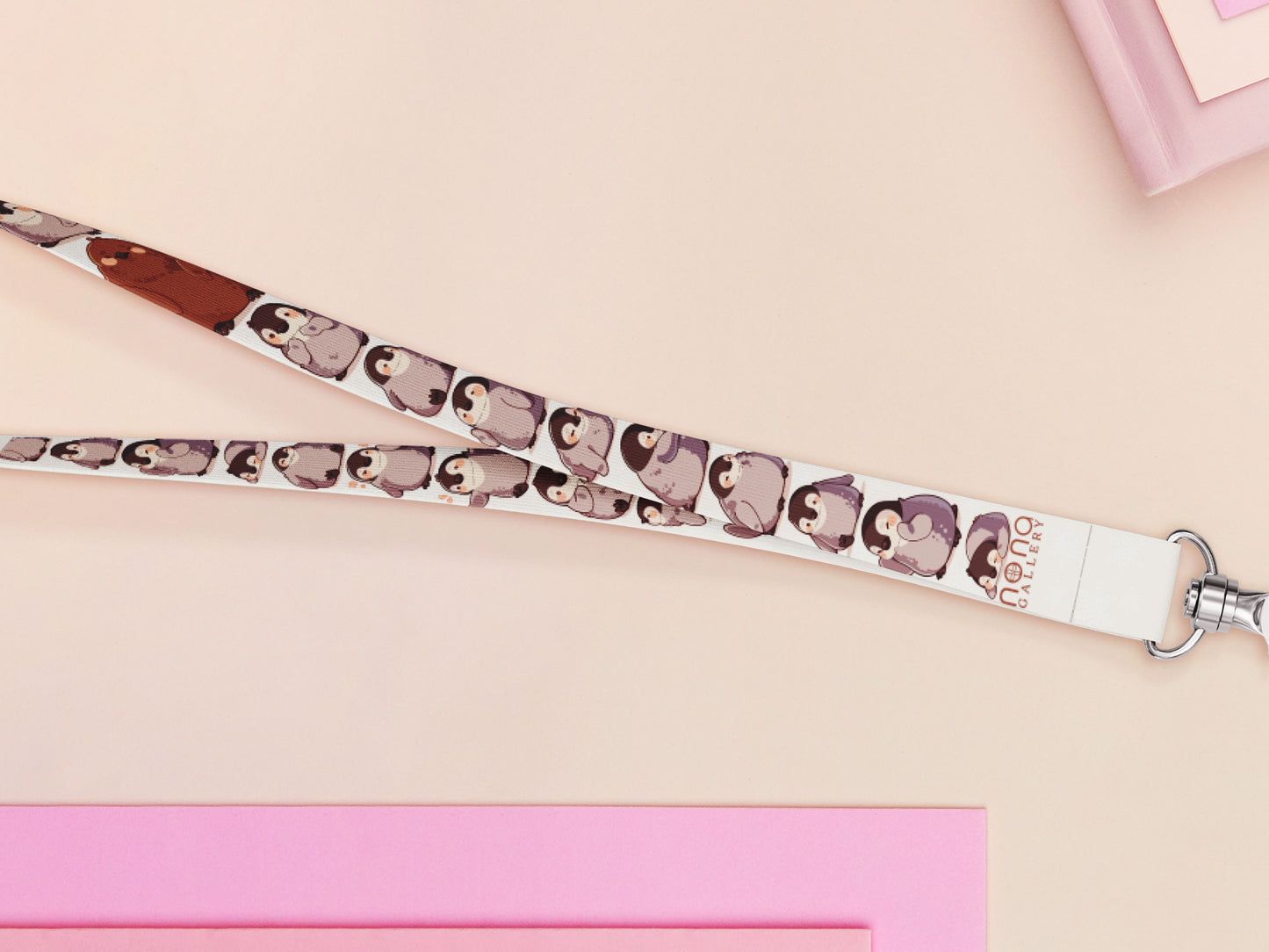 Cute full legth white lanyard with a double sided baby emperor penguin and Pesto pattern and silver swivel hook clasp.