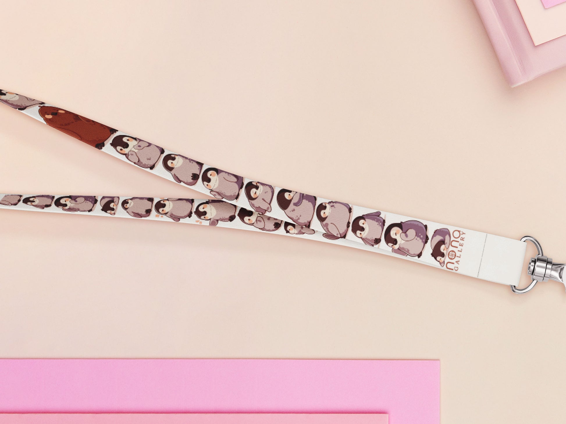 Cute full legth white lanyard with a double sided baby emperor penguin and Pesto pattern and silver swivel hook clasp.