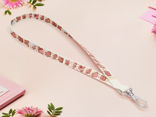 Cute full legth white lanyard with a double sided baby pygmy hippo Moo Deng pattern and silver swivel hook clasp.