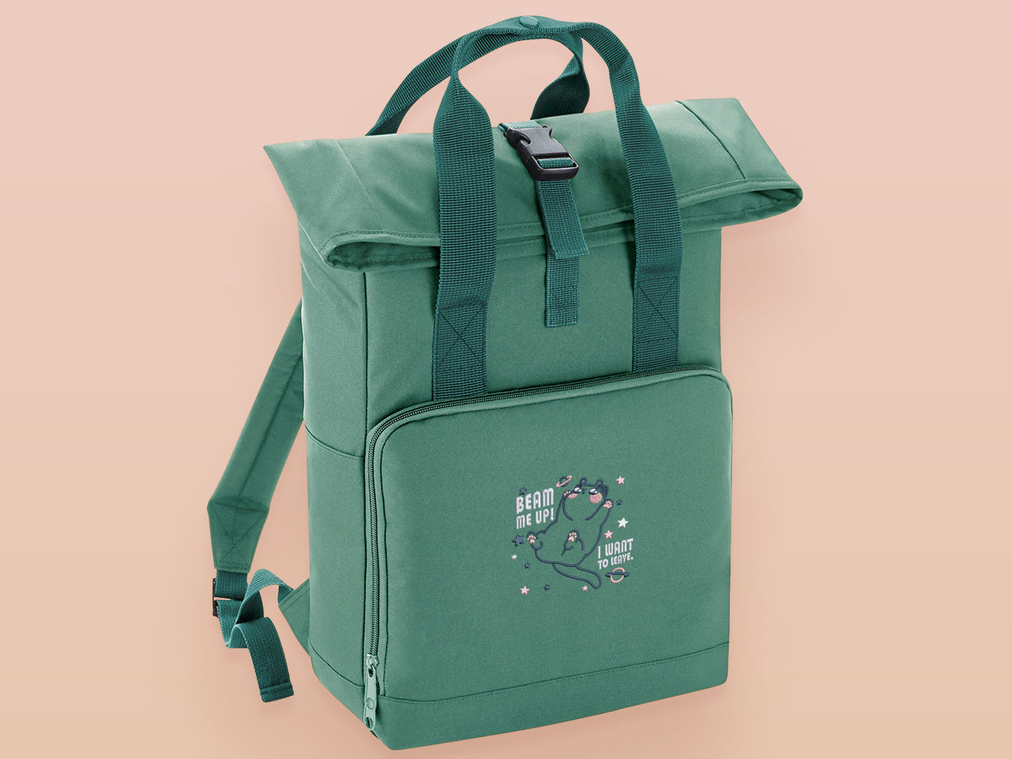 Green roll top twin handle backpack with an embroided design of cute space alien cat floating in the stars and the quote beam me up I want to leave!