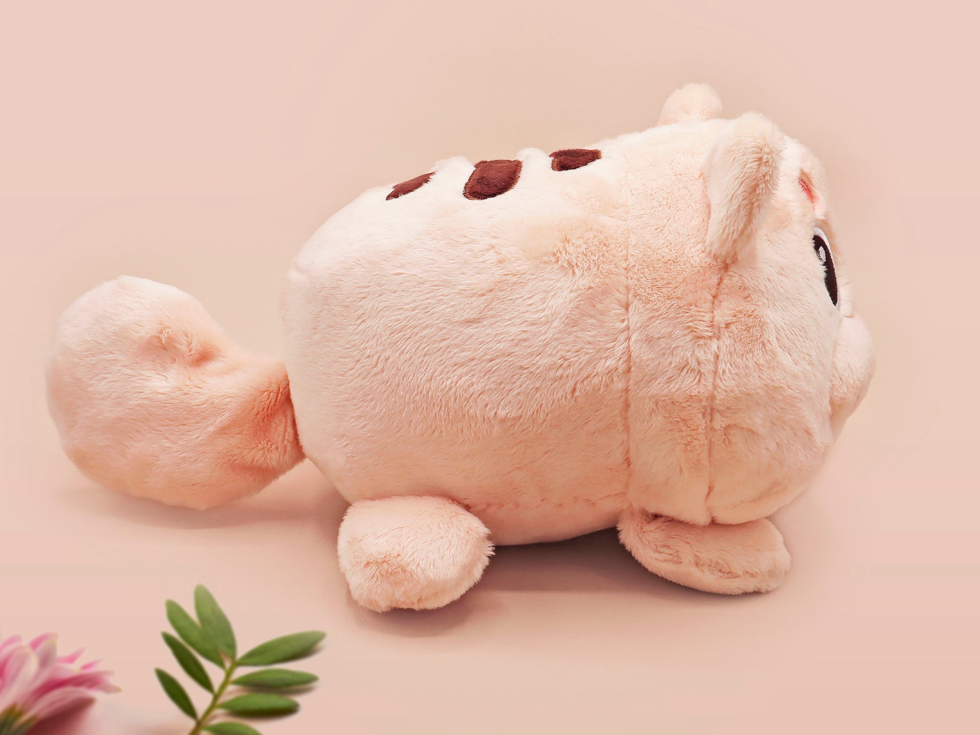 An adorable fluffy cat plushie toy with cute embroidered eyes, facial expression and applique stripes and pawprint toe beans, with a hang tag describing the cat as Brenda.