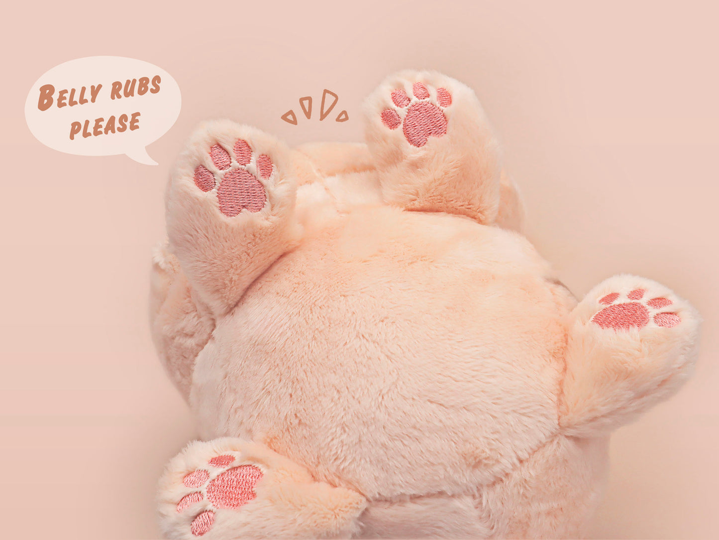 An adorable fluffy cat plushie toy with cute embroidered eyes, facial expression and applique stripes and pawprint toe beans, with a hang tag describing the cat as Brenda.