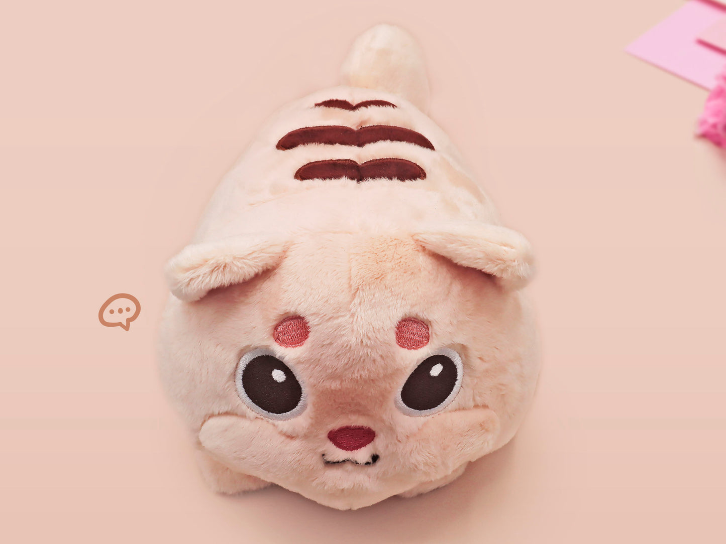 An adorable fluffy cat plushie toy with cute embroidered eyes, facial expression and applique stripes and pawprint toe beans, with a hang tag describing the cat as Brenda.