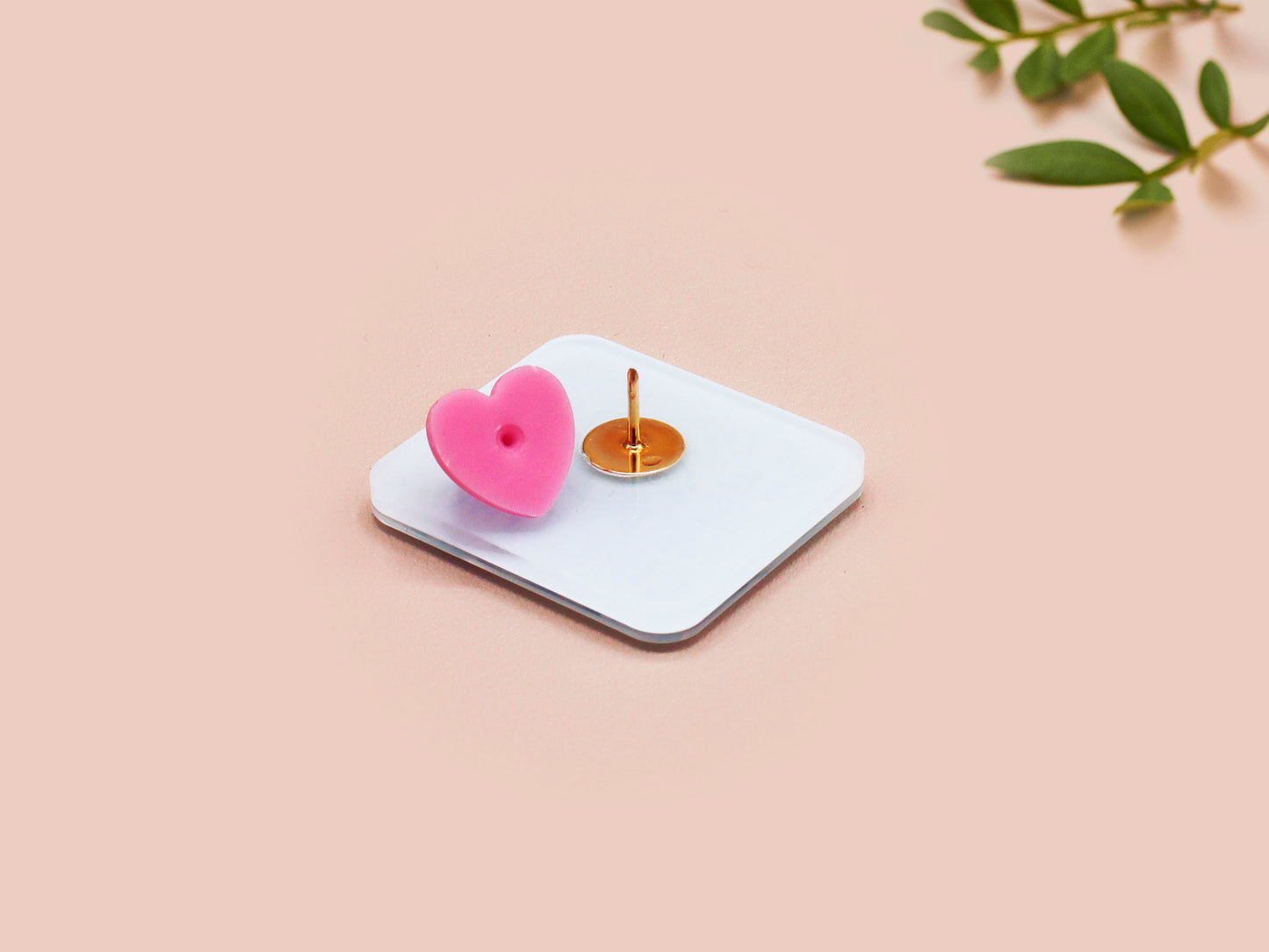 A clear acrylic pin badge with a pink heart-shaped pin back clasp. The design of the pin badge is of a cute chibi blue fish with the quote buy a man eat fish he day teach fish man to a lifetime.