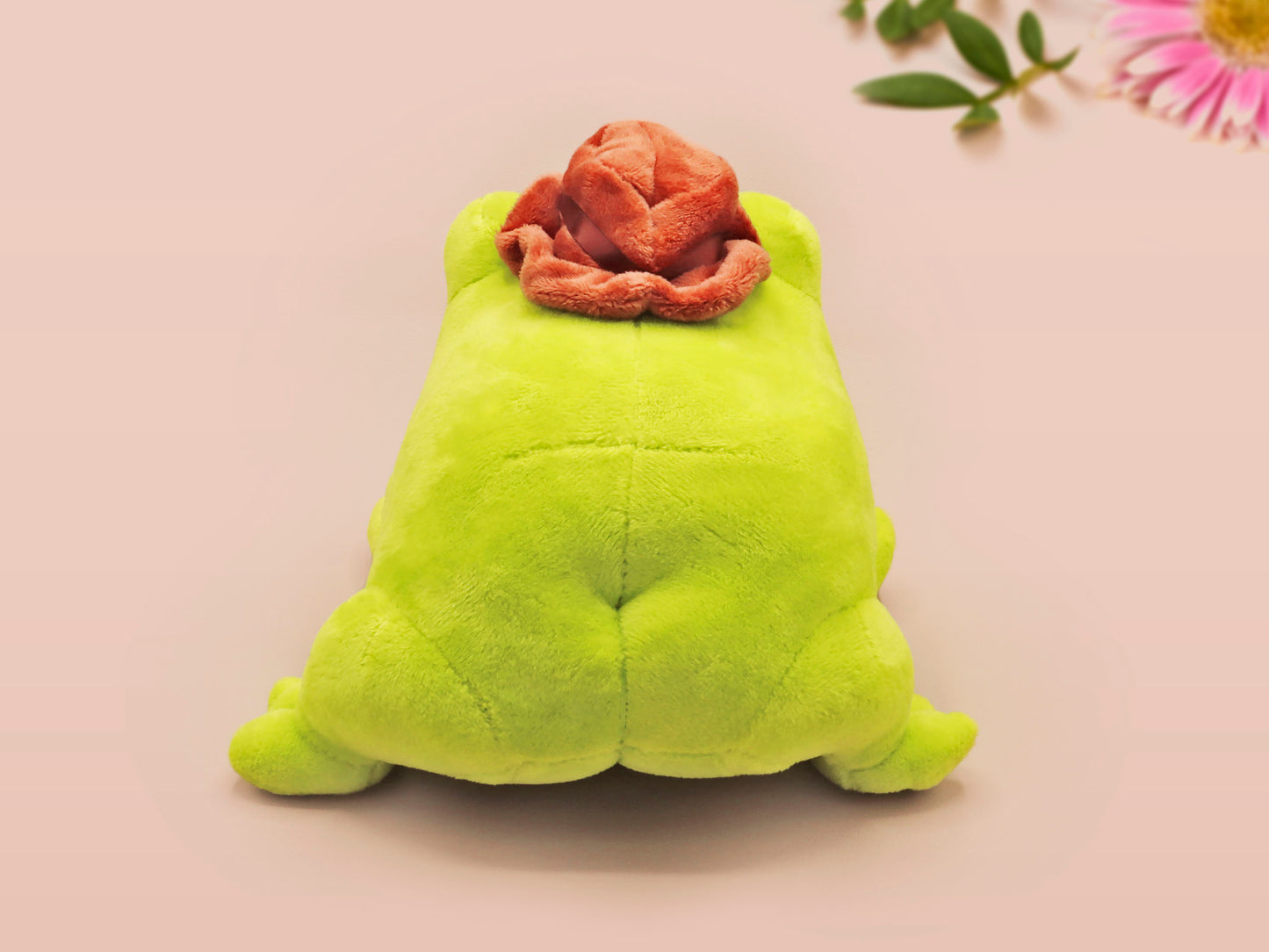 An adorable green frog plushie toy with cute embroidered eyes and facial expression, wearing a cowboy hat with a brown ribbon, and a hang tag describing the frog as Carl.