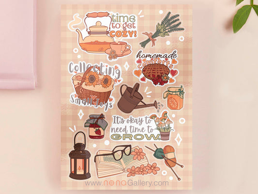 Large sticker sheet of different digital illustration cartoon cottagecore items such as jams, jars, baking, tea, herbs, knitting and books.