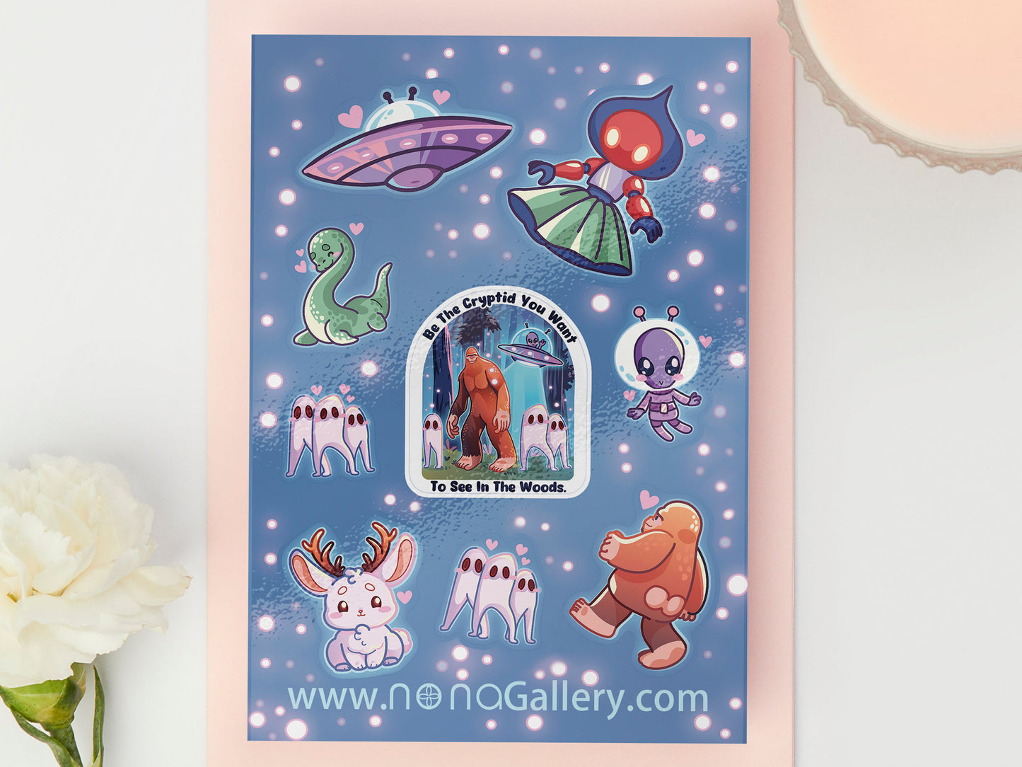 Gloss vinyl sticker sheet of multiple different cute cryptids, aliens and monsters.