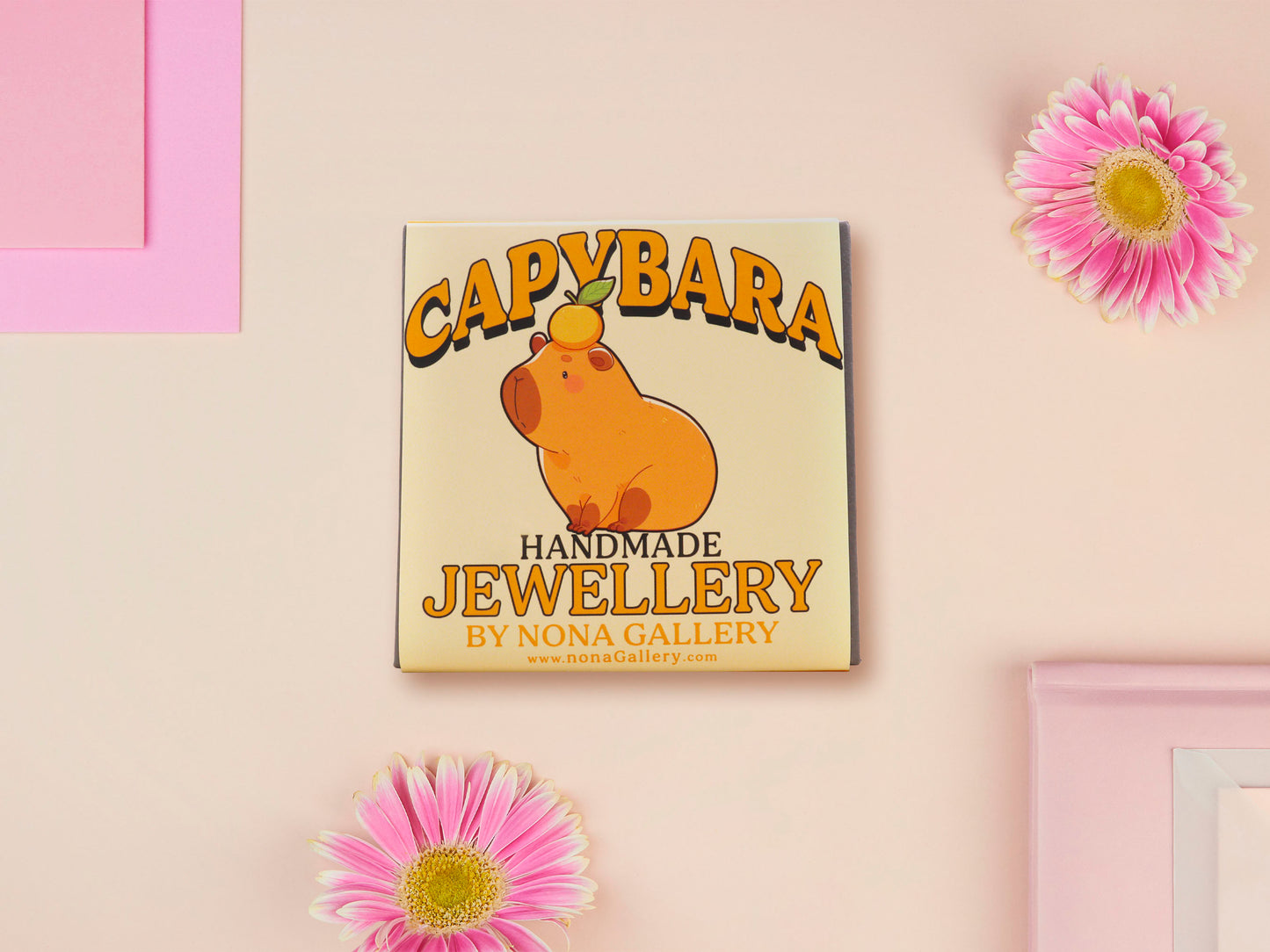 Adorable cute capybara with an orange on its head necklace made of wood and glitter pearlescent acrylic with a gold chain, displayed in a velvet gift box with a unique cute capybara sleeve design.