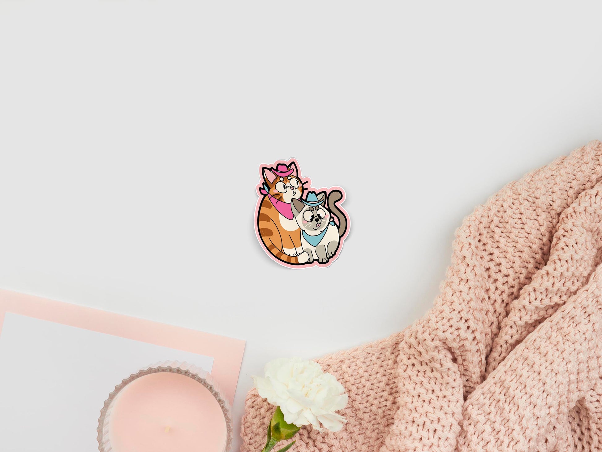 Large sticker of digital illustration cartoon of two cute kittens, one is ginger with stripes, the other is rag doll with grey face and tail. Both wear pink and blue cowboy hats and bandanas