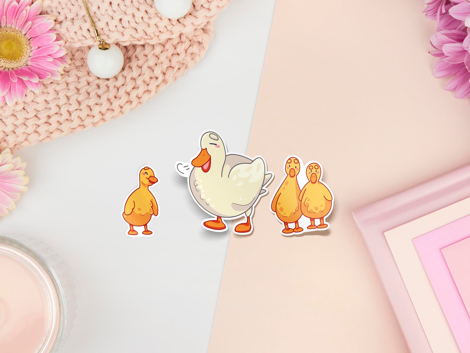 Three stickers of digitally illustrated cartoon ducks, one is a white adult duck the other are three small yellow ducklings