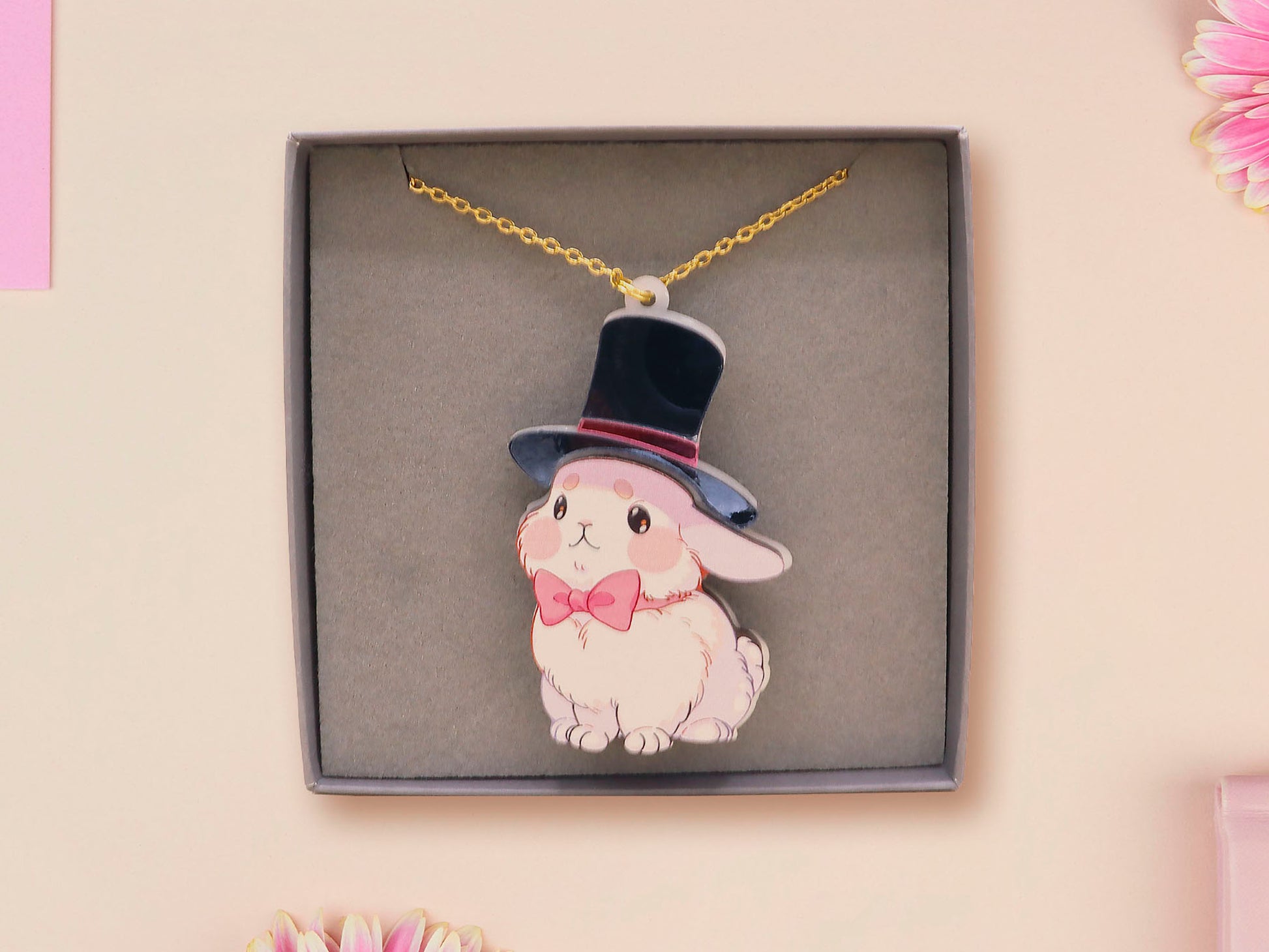 Adorable cute white bunny rabbit wearing a top hat and now tie necklace made of wood and mirror acrylic with a gold chain, displayed in a velvet gift box with a unique cute rabbit sleeve design.