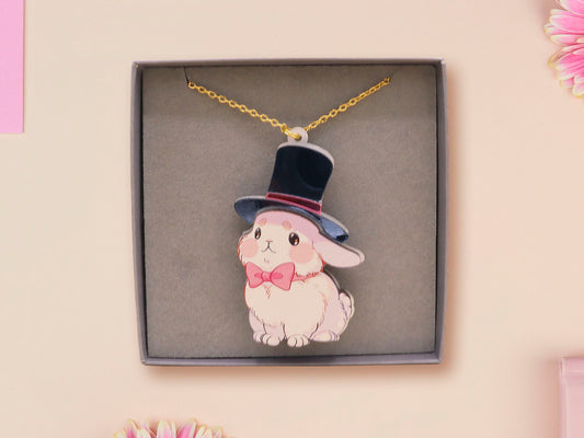 Adorable cute white bunny rabbit wearing a top hat and now tie necklace made of wood and mirror acrylic with a gold chain, displayed in a velvet gift box with a unique cute rabbit sleeve design.