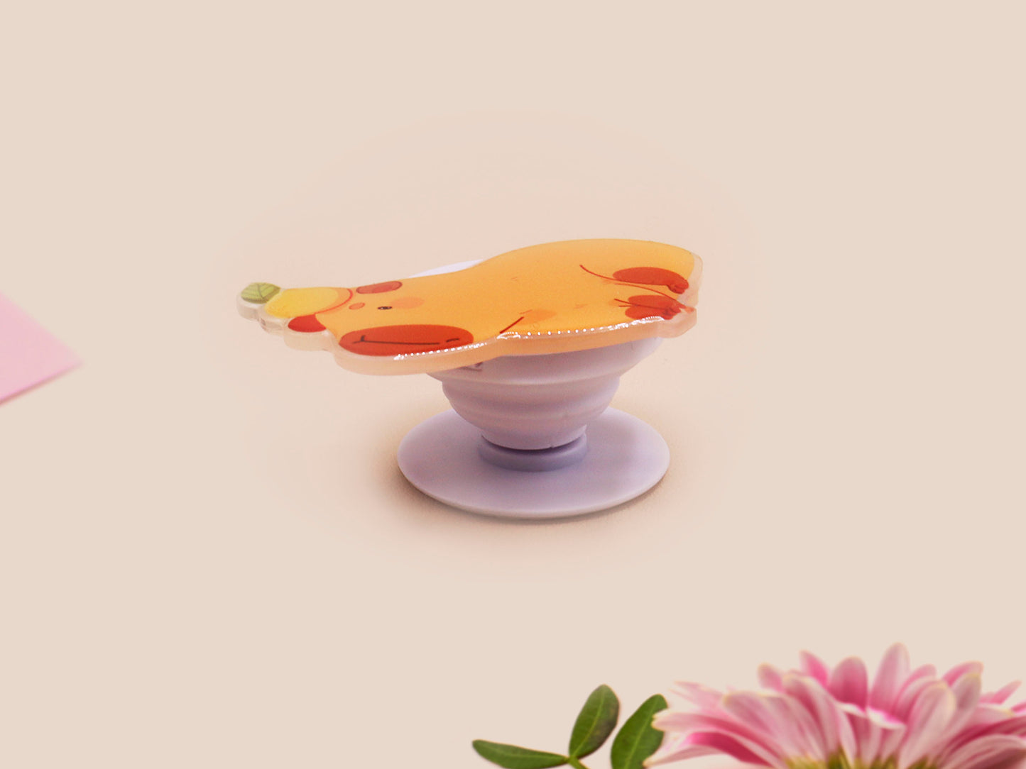 Cute acrylic popsocket phone grip of a capybara with an orange on it's head