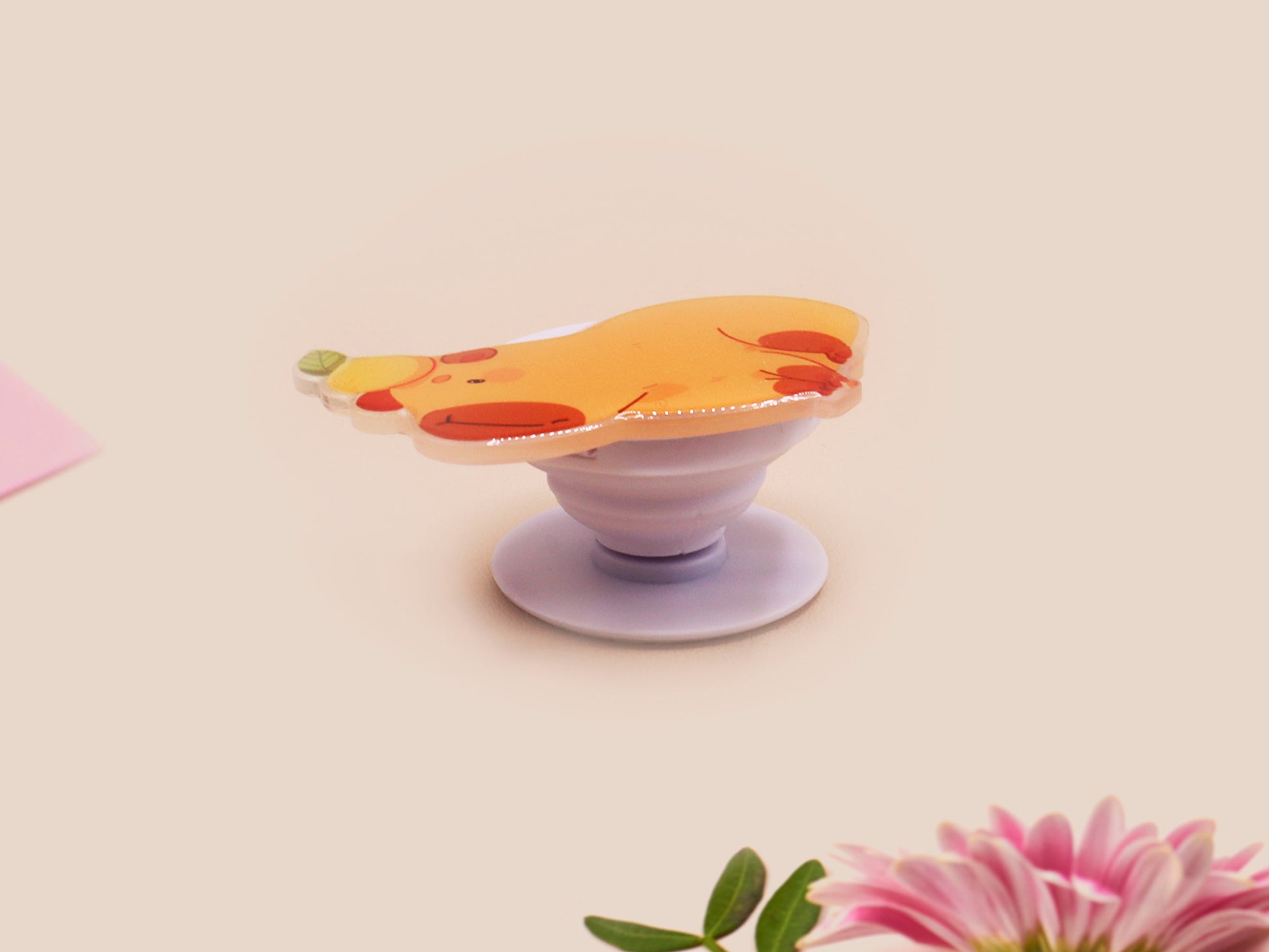 Cute acrylic popsocket phone grip of a capybara with an orange on it's head