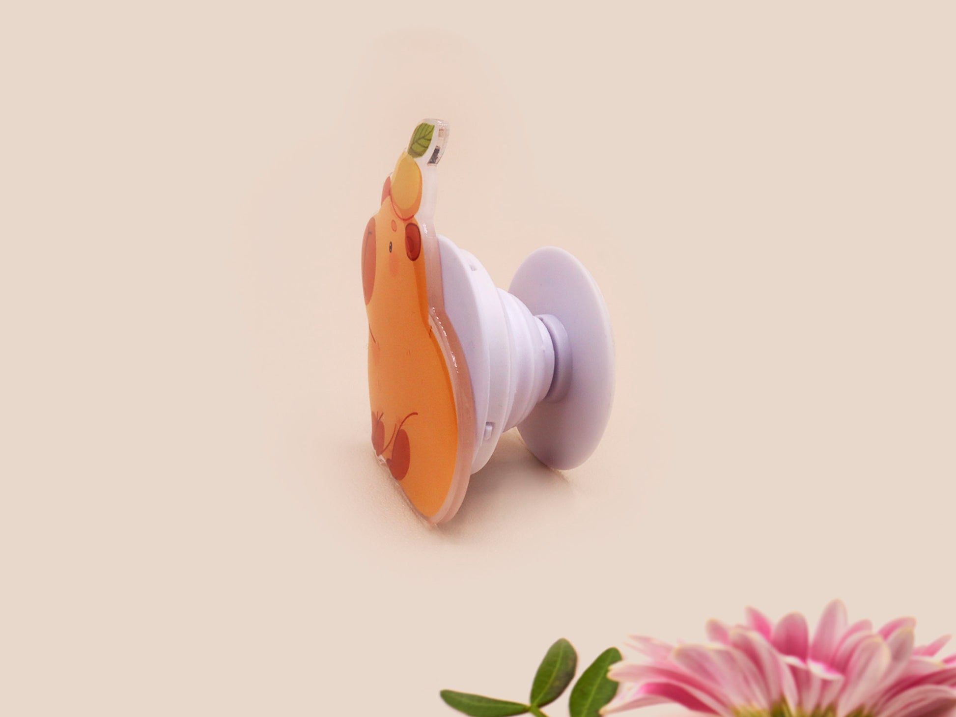 Cute acrylic popsocket phone grip of a capybara with an orange on it's head