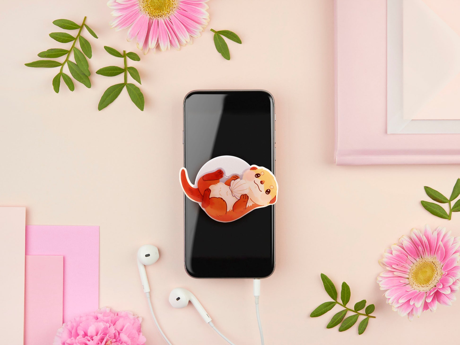 Cute acrylic popsocket phone grip of a sea otter holding a clam shell