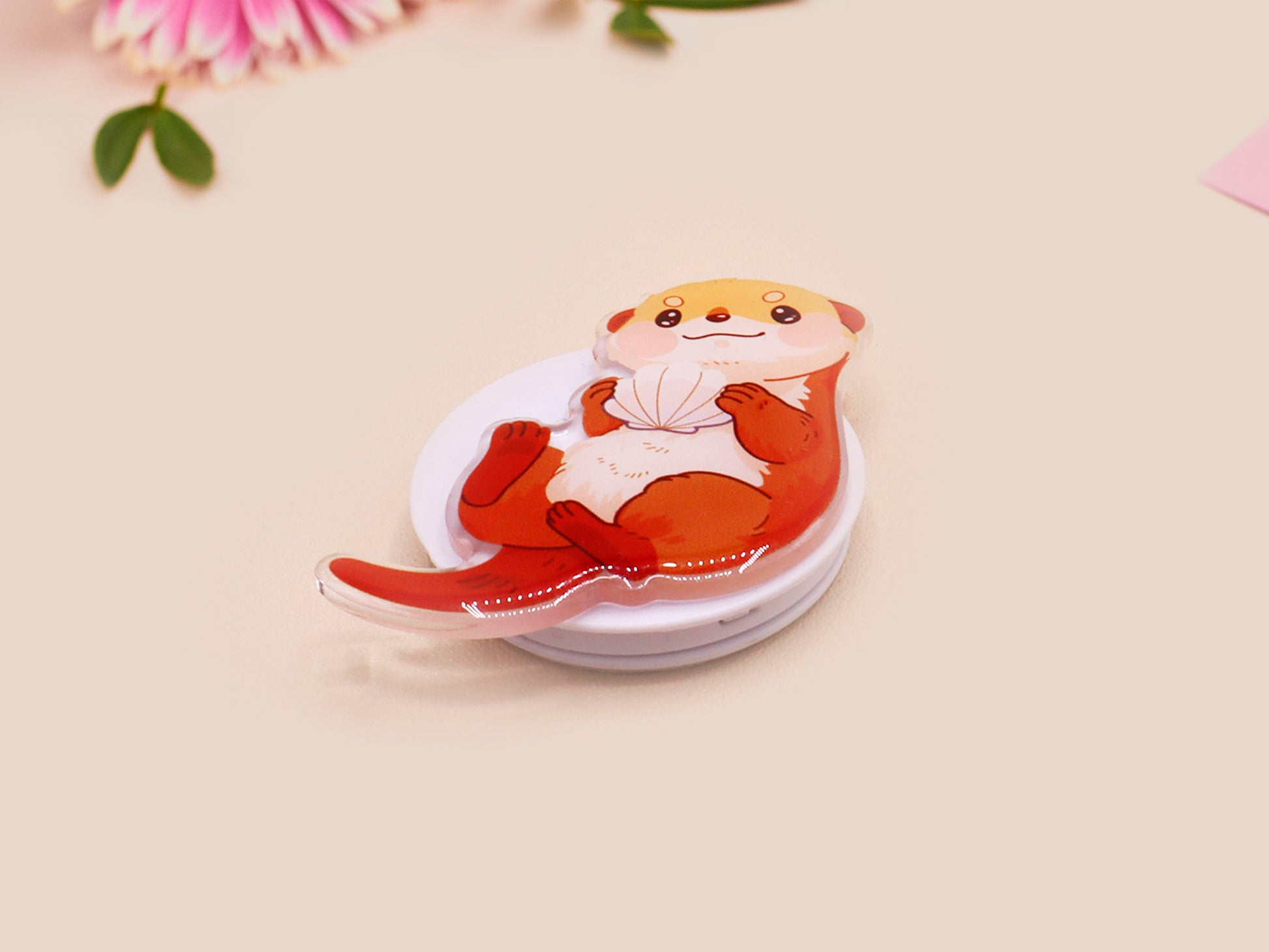 Cute acrylic popsocket phone grip of a sea otter holding a clam shell