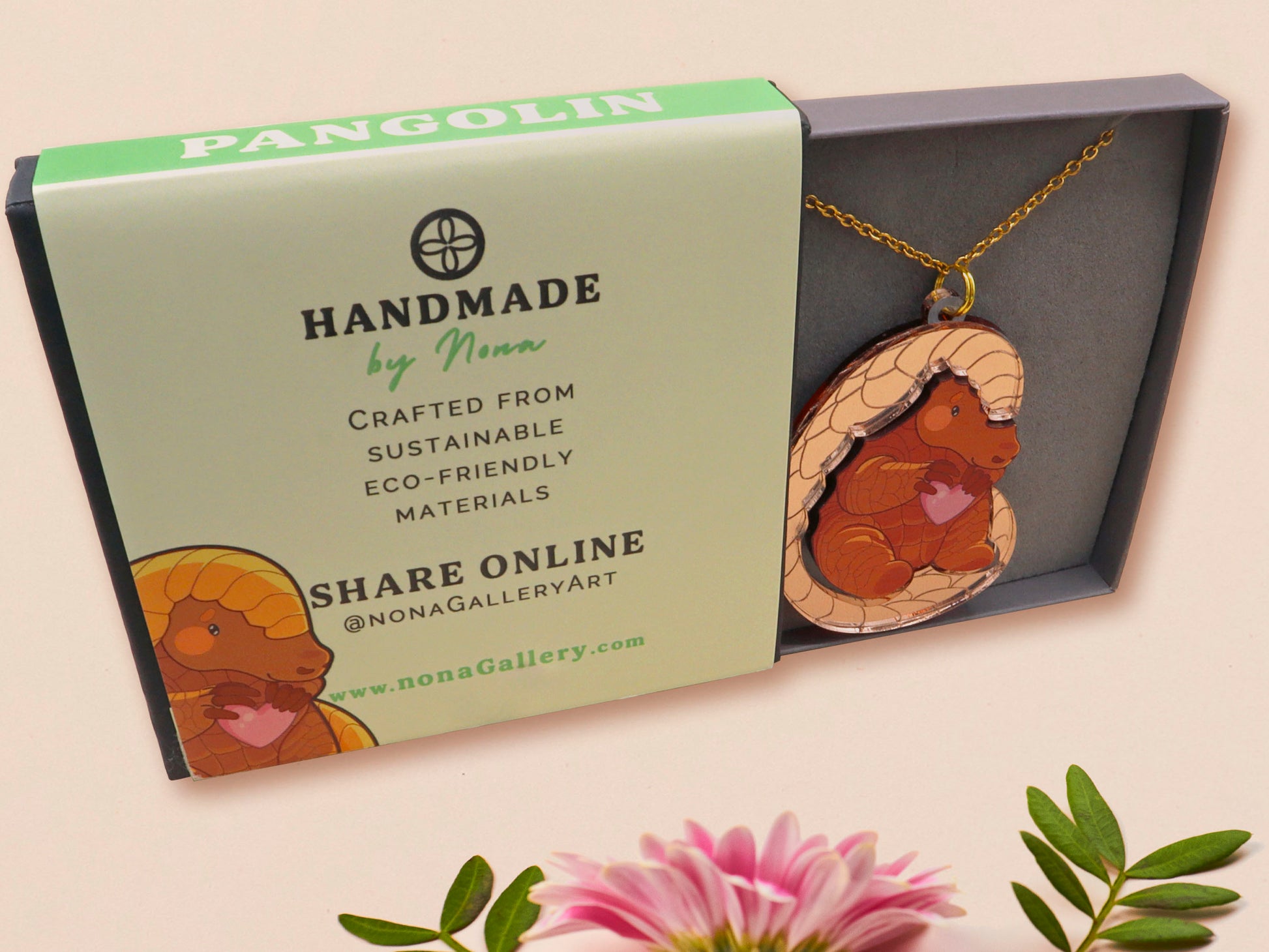 An adorable shy pangolin aardvark holding a heart necklace made of wood and glitter mirror acrylic with a gold chain is displayed in a velvet gift box with a unique cute Pangolin sleeve design.