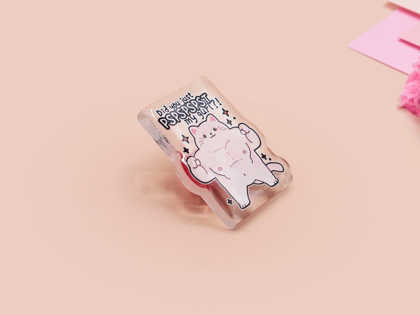 Cute transparent acrylic pin badge with a pink heart-shaped pin back clasp. The design of the badge is a chibi hench and buff cat with the quote Did you justPSPSPSPSPST my gurl?!