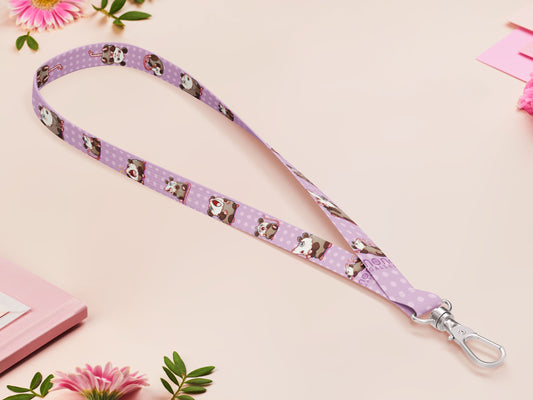 Cute full legth purple lanyard with a double sided funny screaming possums  pattern and silver swivel hook clasp.