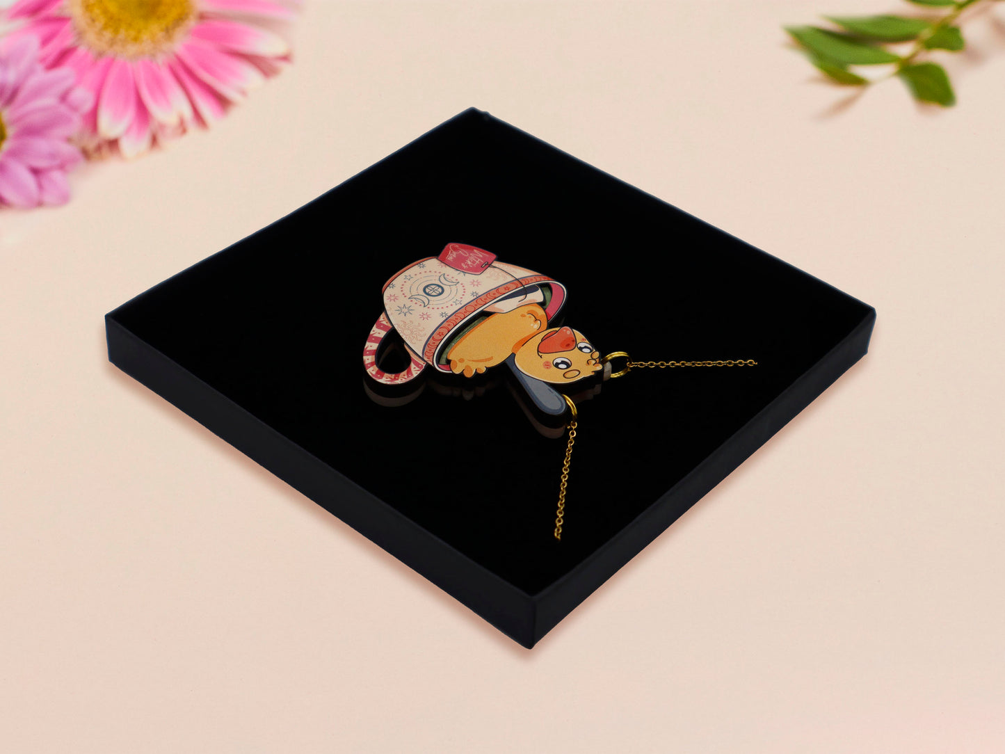 Mixed material handmade necklace of chibi cartoon duck sat in a pearlescent witch's brew teacup, with a gold chain and black gift box.