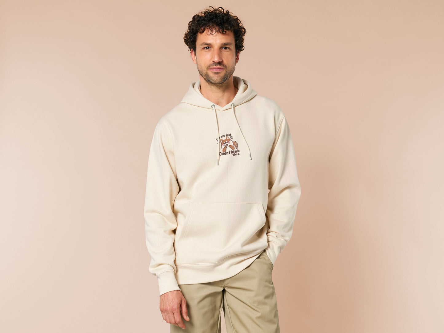 A cream crew neck long sleeve hoodie, with an embroidered design of a cute shiba inu dog looking stressed surrounded by the quote Let Me Just Overthink This