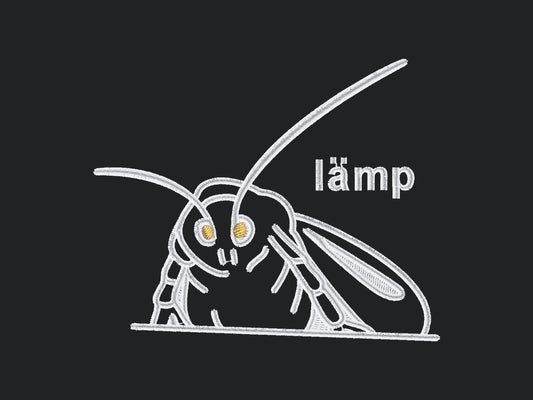 A grey crew neck short sleeve t-shirt, with an embroidered white thread design of a moth with glowing yellow eyes and the word lämp