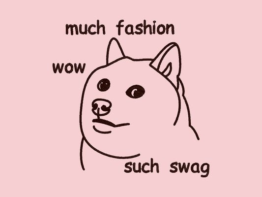 A pink crew neck short sleeve t-shirt, with an embroidered brown thread design of cute shiba inu dog viral doge meme face with the text much fashion wow such swag