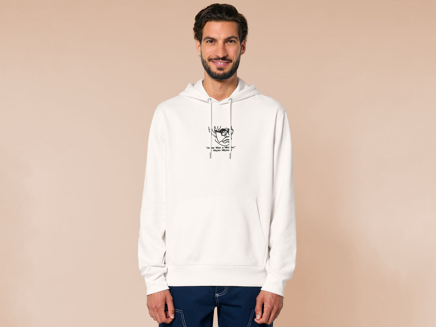 A off white crew neck long sleeve hoodie, with an embroidered black thread design of a portrait of a depressed Hayao Miyazaki the creator of Studio Ghibli with text underneath that reads "Anime Was A Mistake." - Hayao Miyazaki