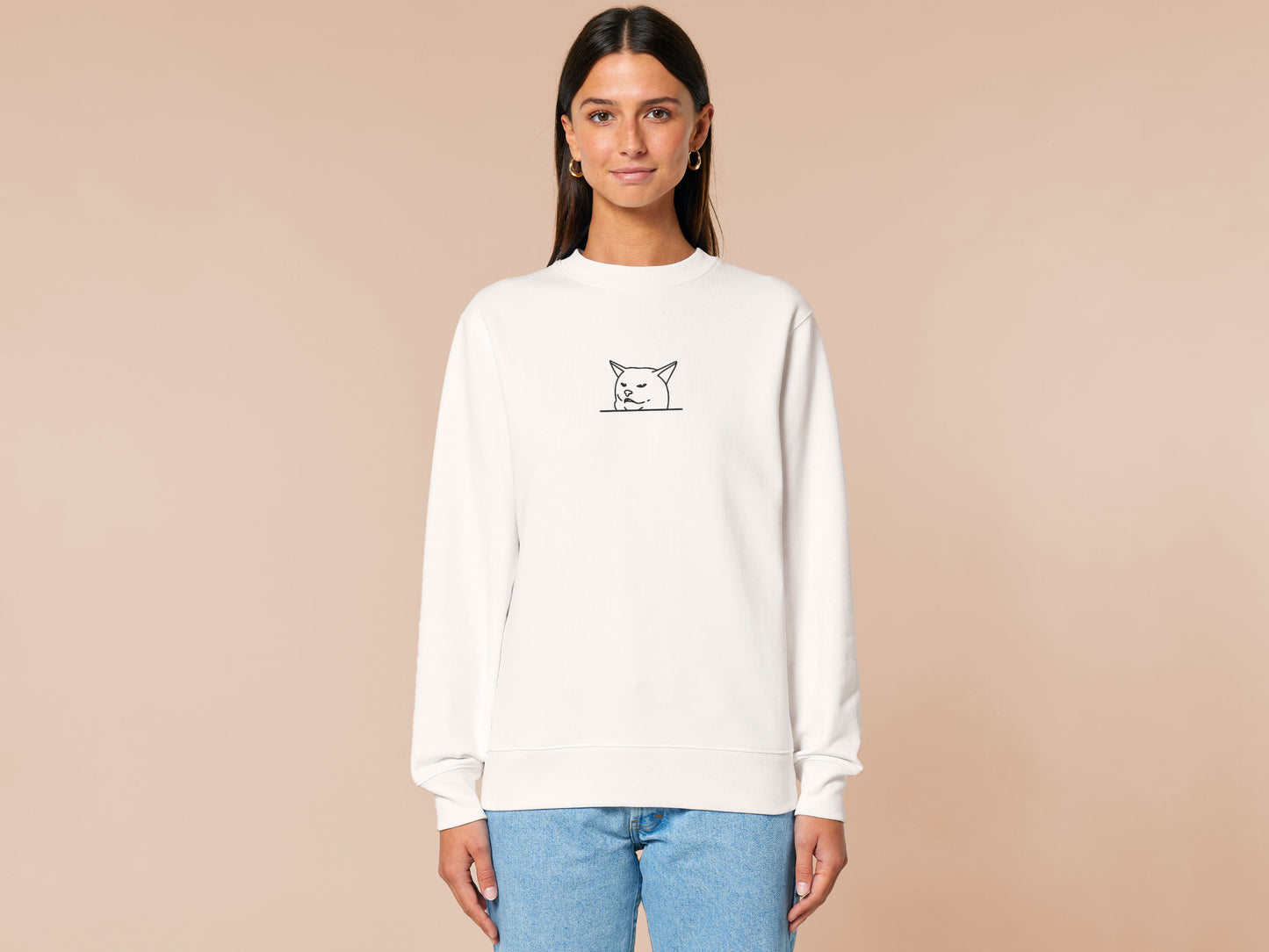 An off-white crew neck long sleeve sweater, with an embroidered black thread design of cute smudge the hissing cat meme reaction