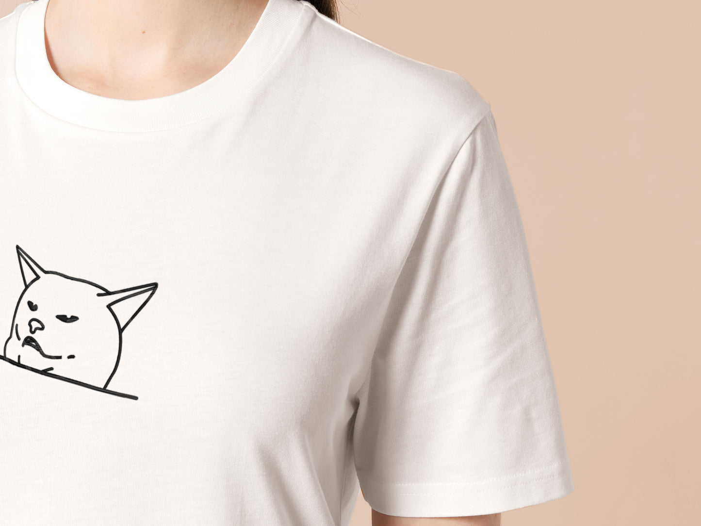 An off-white crew neck short sleeve t-shirt, with an embroidered black thread design of cute smudge the hissing cat meme reaction