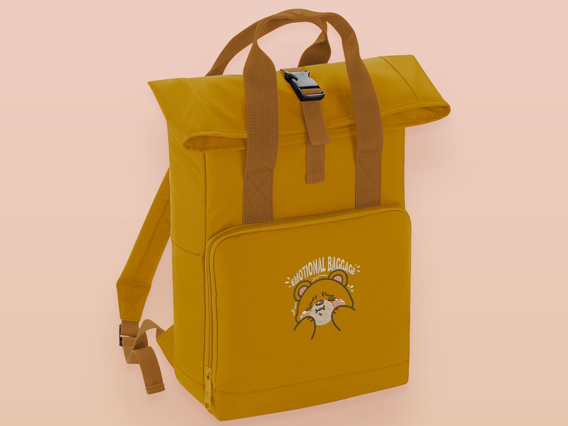 Yellow roll top twin handle backpack with an embroided design of cute crying bear and the quote emotional baggage