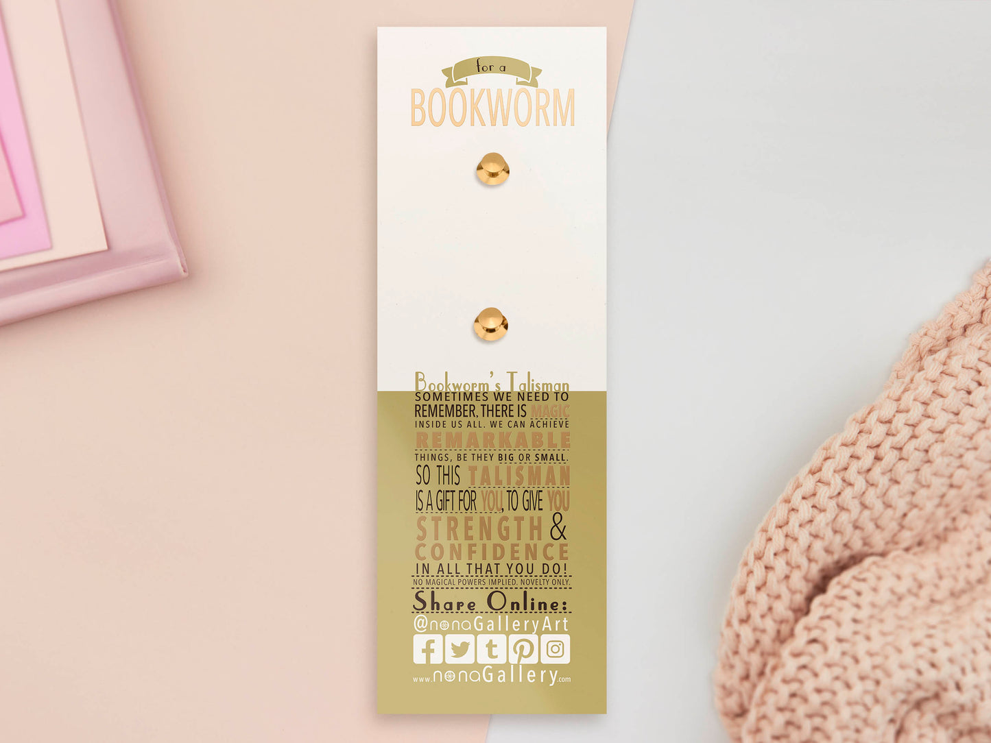 The back of the long white and green backing card with gold accents. The backing card details the symbolism of the different design elements of the Talisman pin. Also shown is the two gold locking pin backs attached to the card.
