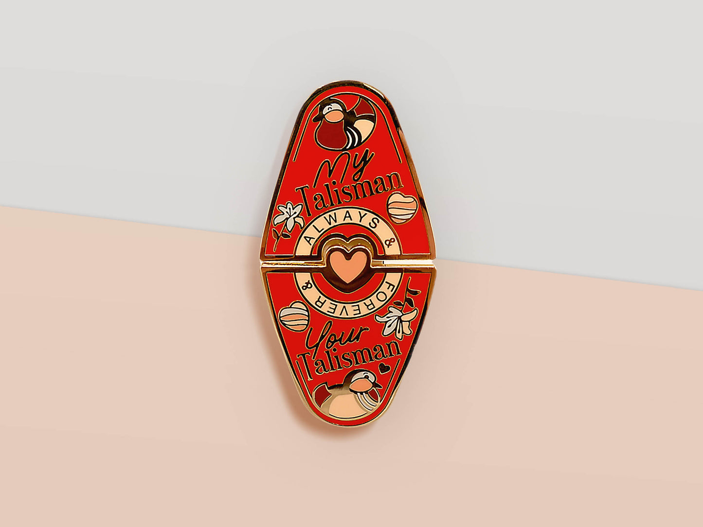 Gold Enamel Talisman Pin with red design and the words Couple's Talisman, Always & Forever. The pins design includes a hearts, ducks, as well as flowers and crystals.