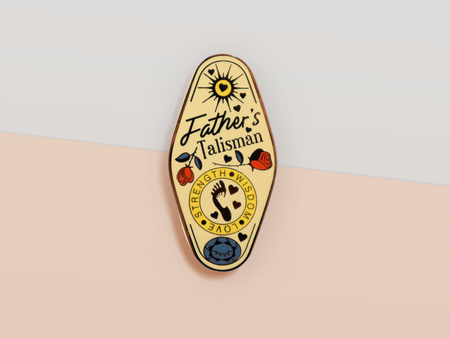 Gold Enamel Talisman Pin with yellow design and the words Father's Talisman, Strength Wisdom Love. The pins design includes a fathers and child's footprint, sunshine, hearts, as well as flowers and crystals.