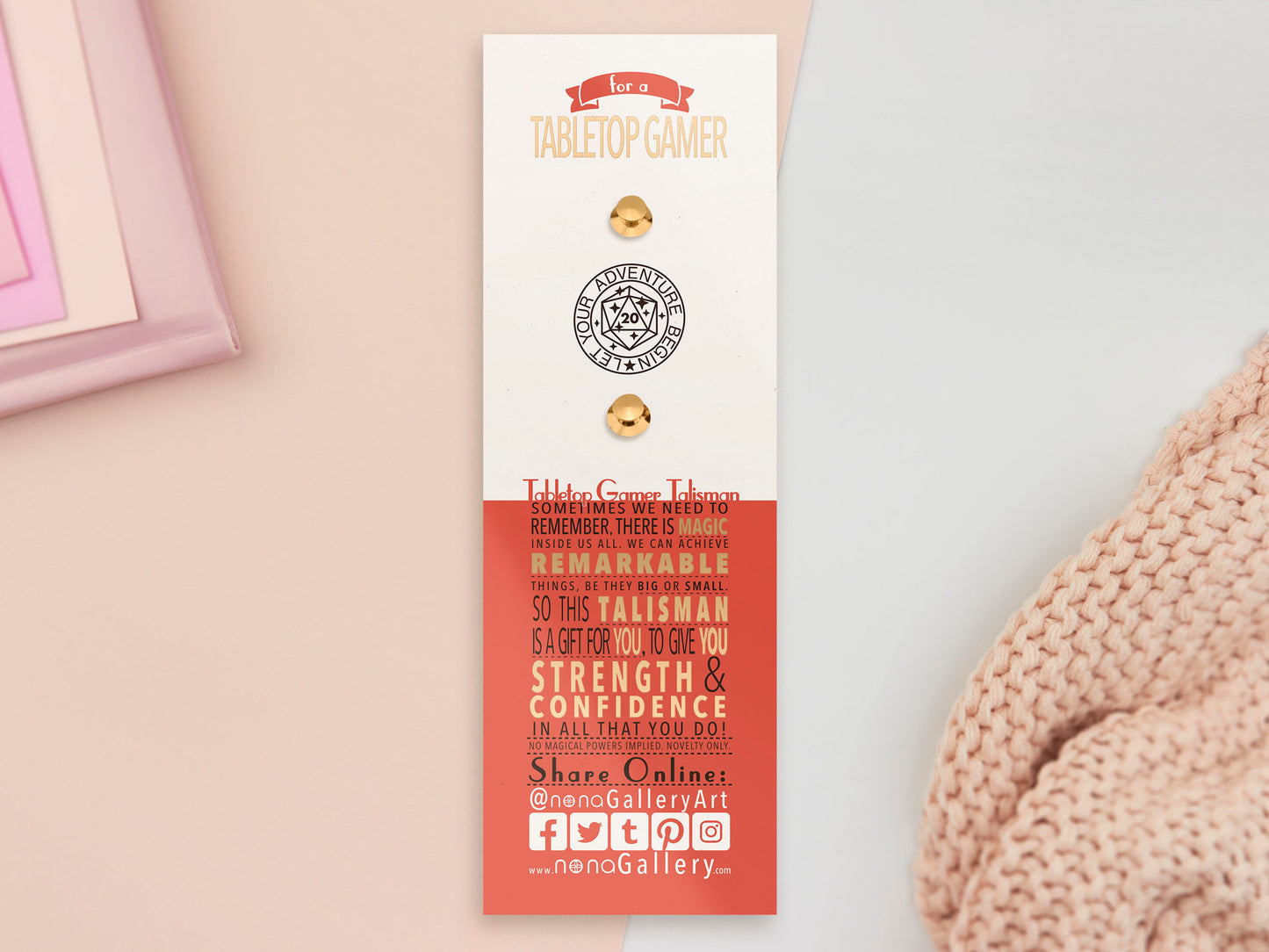 The back of the long white and red backing card with gold accents. The backing card details the symbolism of the RPG talisman different design elements. Also shown is the two gold locking pin backs attached to the card.