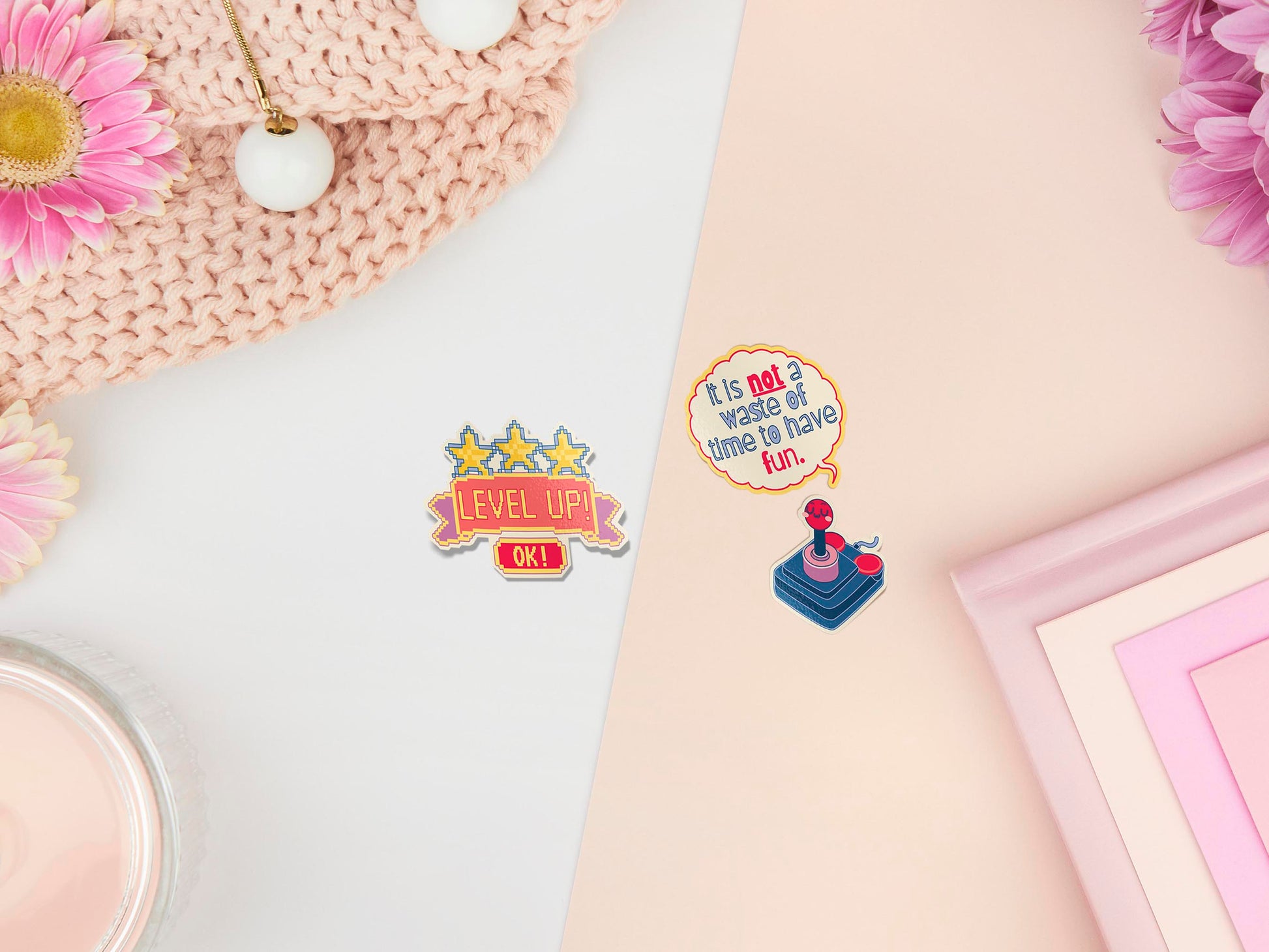 Three peelable stickers the first is a pixelated star design with the text Level Up! and a button that says OK! The second sticker is a speech bubble with the text It is not a waste of time to have fun. The third sticker is a retro joystick controller with a cute face.